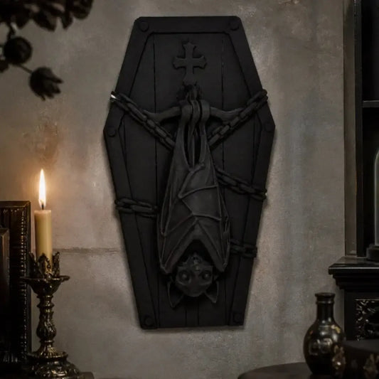 Coffin-shaped plaque with hanging bat displayed on a gothic wall