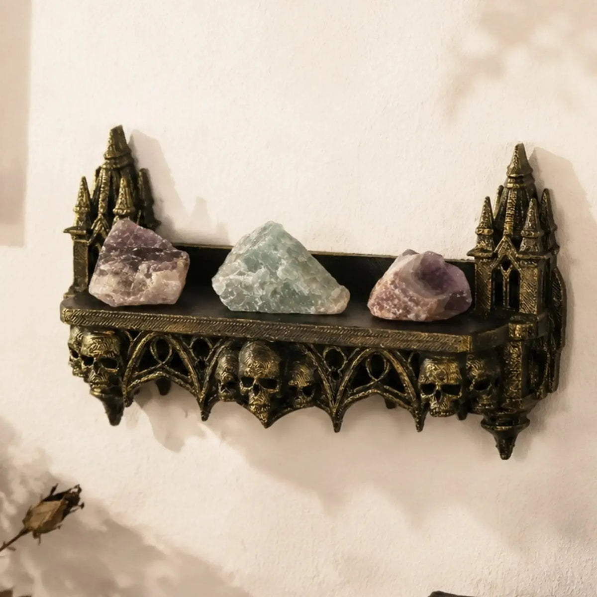 Close-up of the carved turret and skull detail on the wall shelf