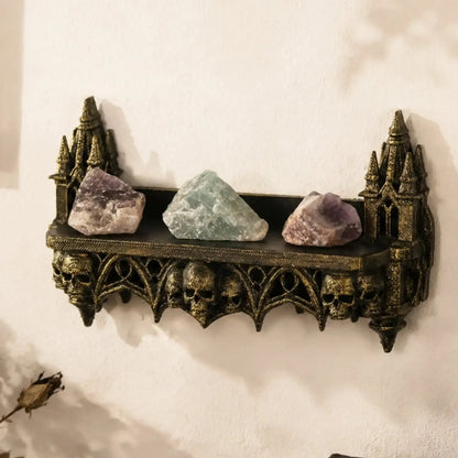 Close-up of the carved turret and skull detail on the wall shelf