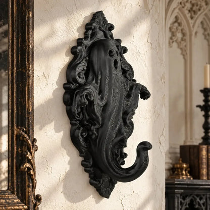 Ghost wall hook angled view showing draped figure and ornate backplate
