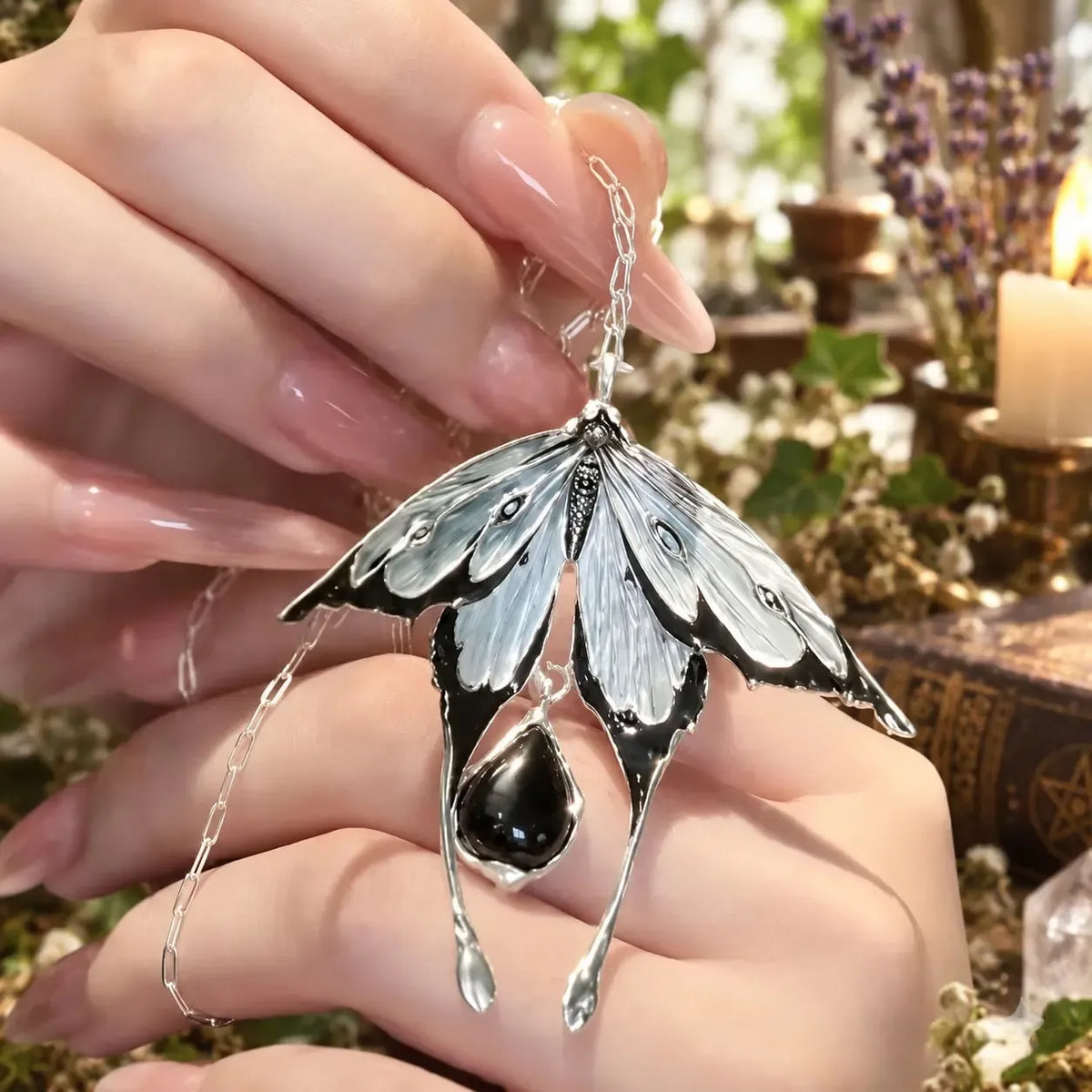 Hand-held view of detailed moth wings and teardrop