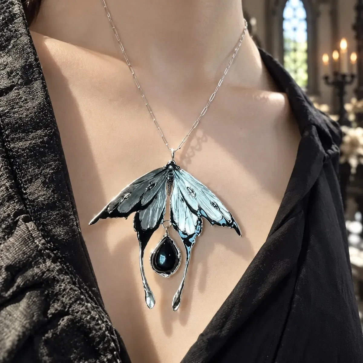 Moth necklace worn with an open dark neckline