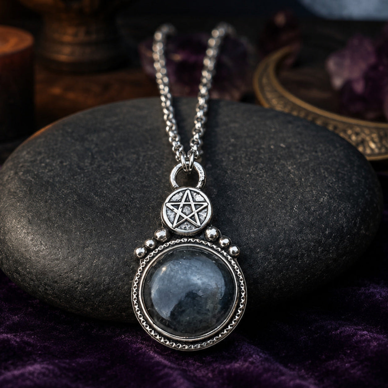 Round stone pentagram amulet necklace on moonlit Pagan altar