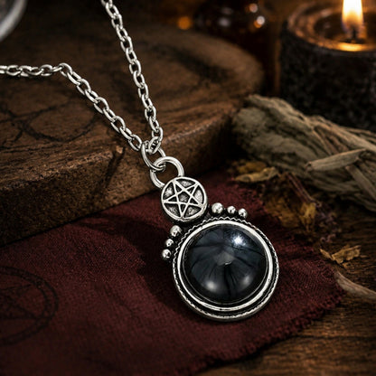 Gothic pentacle pendant necklace with polished black stone and candlelight