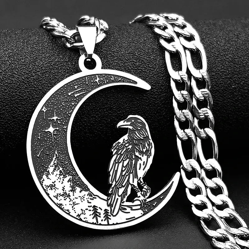 Silver necklace with a crescent moon and raven pendant on a black background