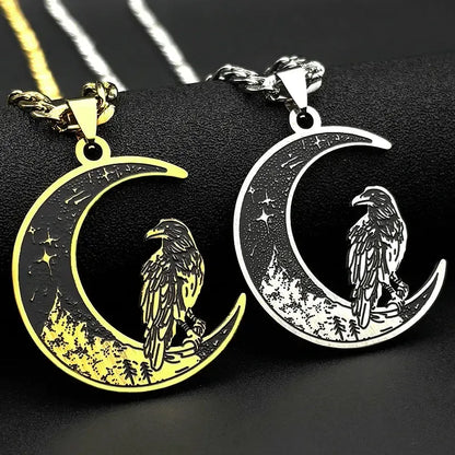 Two moon-shaped pendants with eagle designs, one gold and one silver, on a black background.