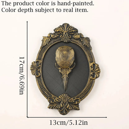 Accented plaque measurement diagram: Gothic Raven Skull Wall Plaque, featuring a raven skull relief surrounded by an elaborate oval frame.