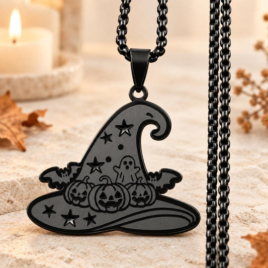 Black Gothic Witch Hat Necklace with pumpkin, ghost, bat and star details on a light ivory altar with autumn accents.