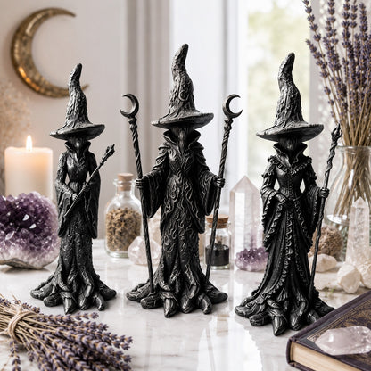 Gothic witch resin statue set of three with staffs near crystals and candles