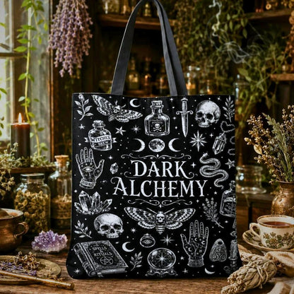 Dark Alchemy black tote bag with moth, skull, snake, moon phases, and Spells Rituals book illustrations