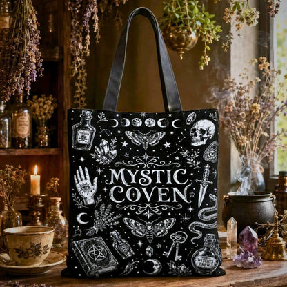 Mystic Coven black tote bag with moon phases, skull, moth, hand-eye symbol, and Witches Brew bottle illustrations