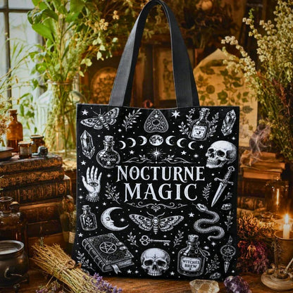 Nocturne Magic black tote bag with moth, moon phases, skulls, crystals, and Witches Brew bottle illustrations
