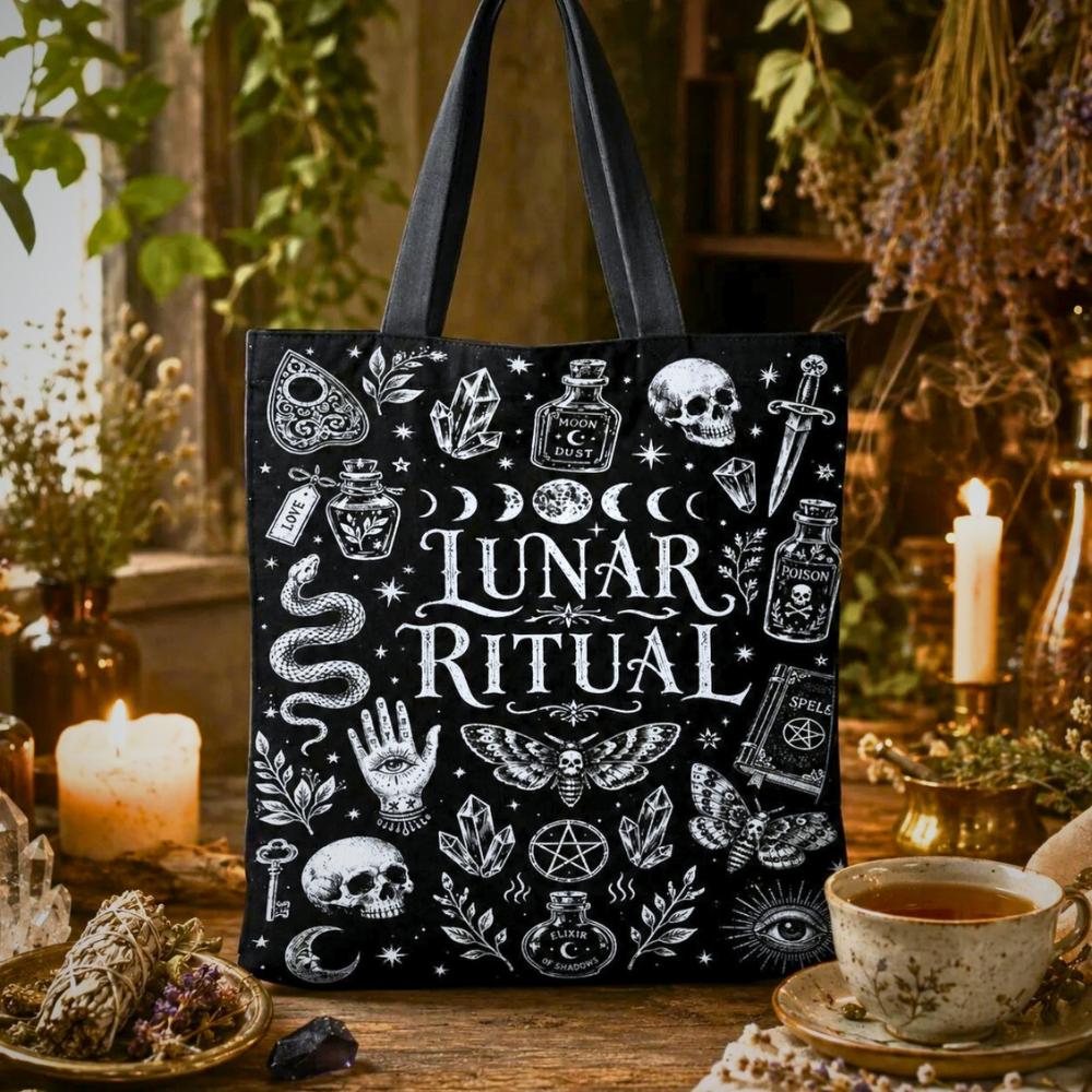 Lunar Ritual black tote bag with moon phases, crystals, skull, snake, moth, and hand-eye illustrations