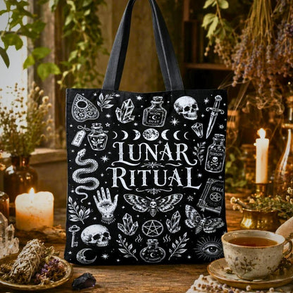 Lunar Ritual black tote bag with moon phases, crystals, skull, snake, moth, and hand-eye illustrations