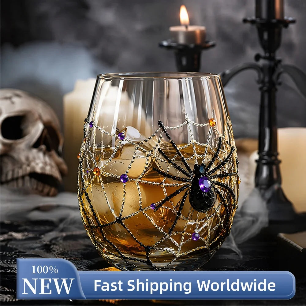 Halloween spider web 3D glass filled with whiskey beside skull and candles