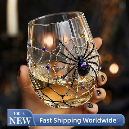 Hand holding Halloween spider web 3D glass filled with white wine