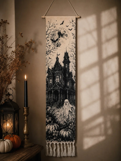 Halloween haunted house tapestry hanging by window with candle lantern
