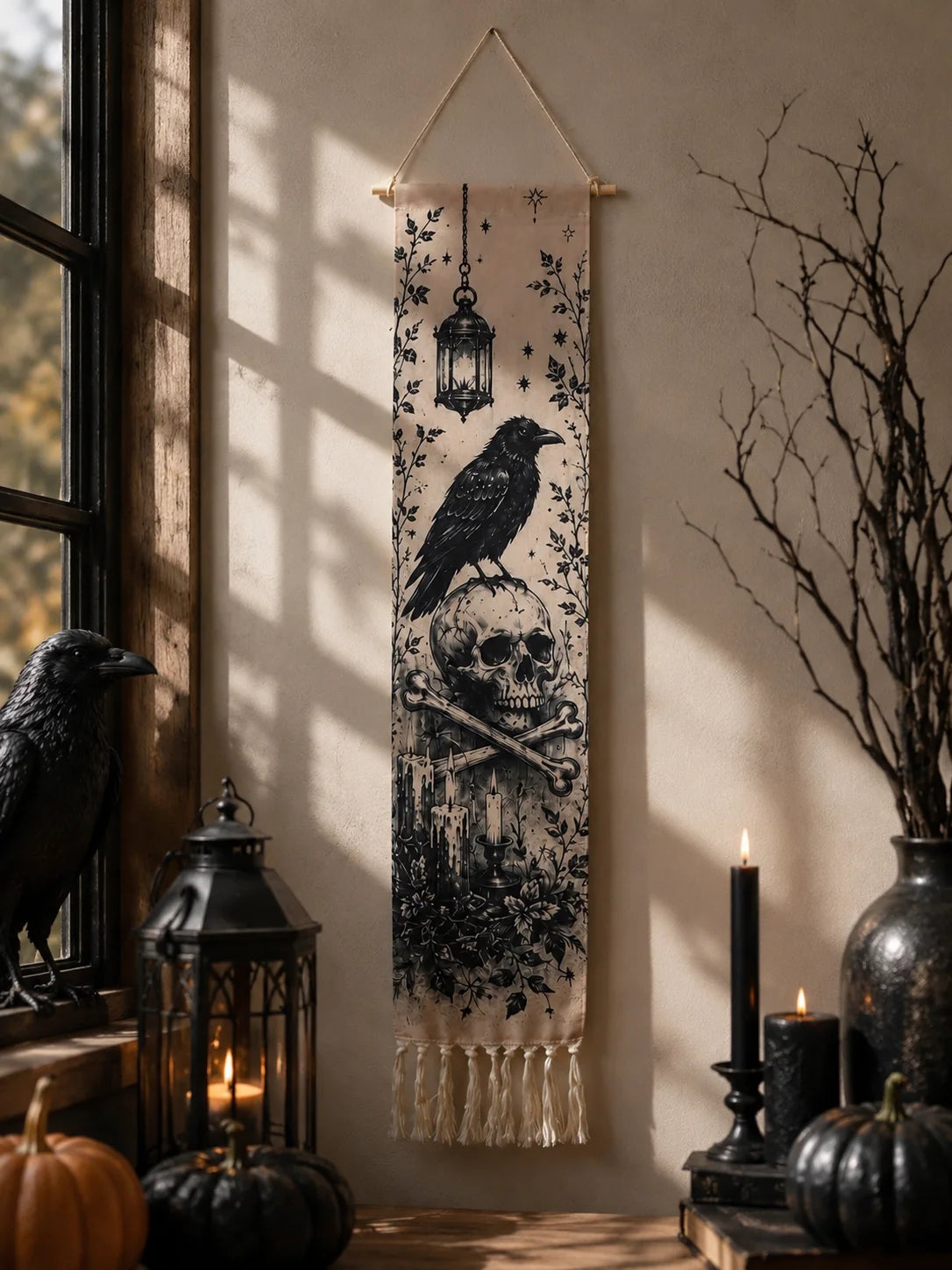 Halloween crow and skull tapestry hanging by window with lantern and candles