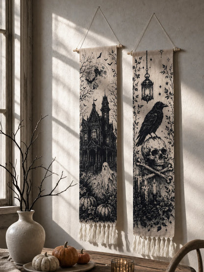 Halloween haunted house and crow skull tapestries hanging in window with pumpkins and vase