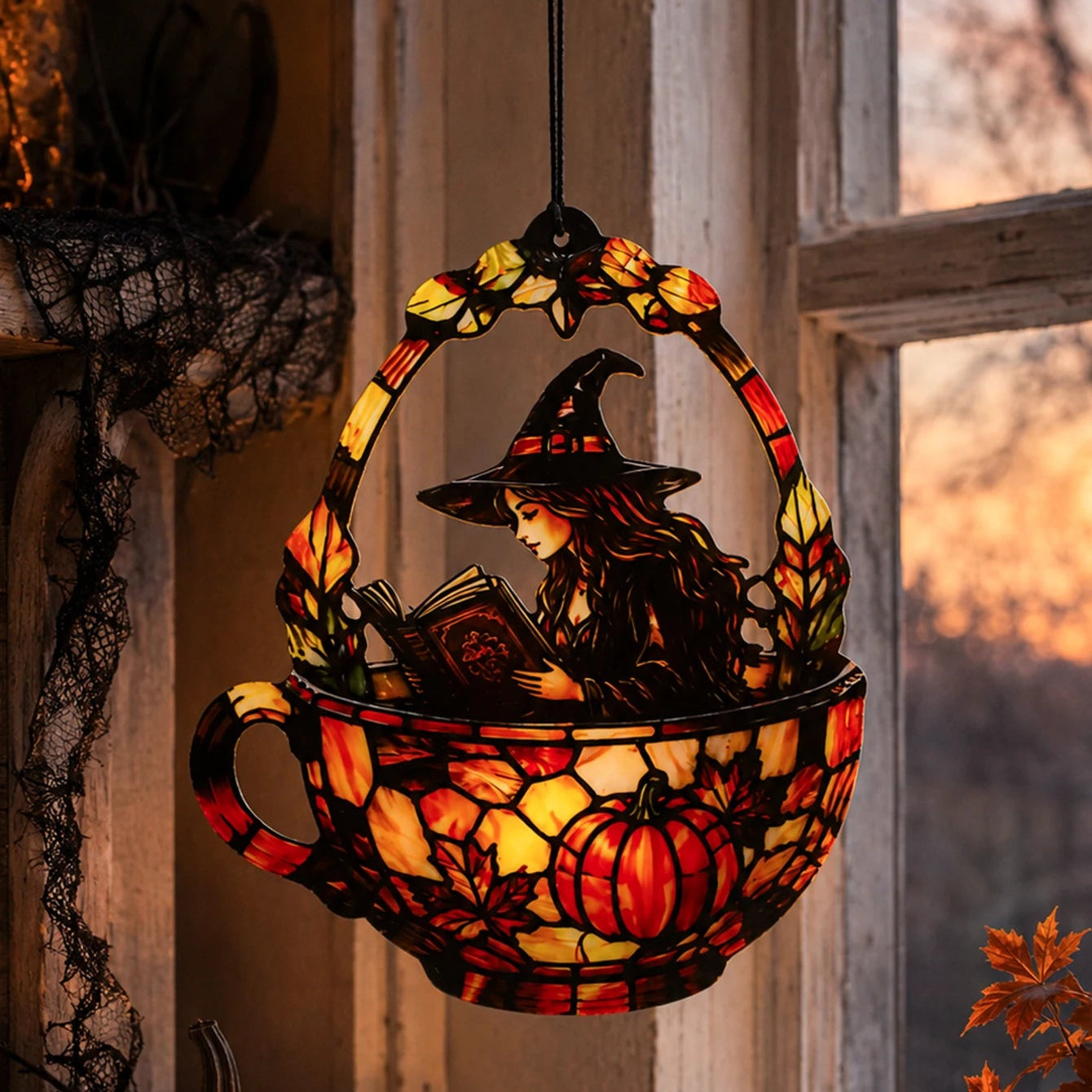 Halloween witch teacup suncatcher hanging near spooky cobweb window decor
