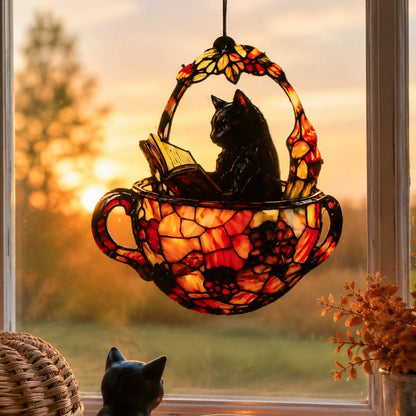 Halloween black cat teacup suncatcher hanging in sunlit window with cat figurine