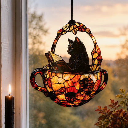Halloween black cat teacup suncatcher hanging by window with candle at dusk