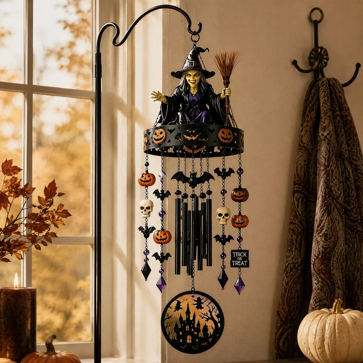 Halloween wind chime hung from a garden branch