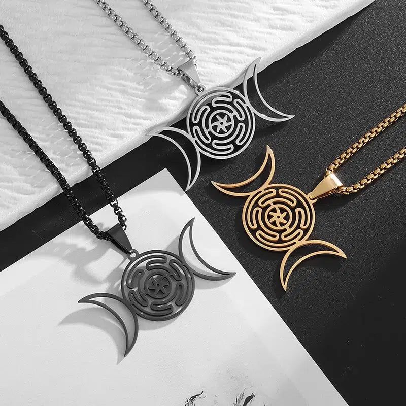 Three stainless steel Hecate Wheel Triple Moon necklaces in silver, gold, and black, showcasing intricate Wicca jewelry.