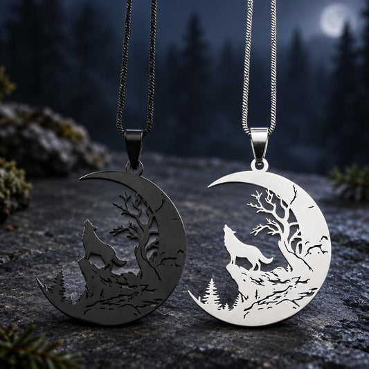 Black and silver Howling Wolf Crescent Moon Necklaces with tree cutouts displayed together on moonlit dark stone.