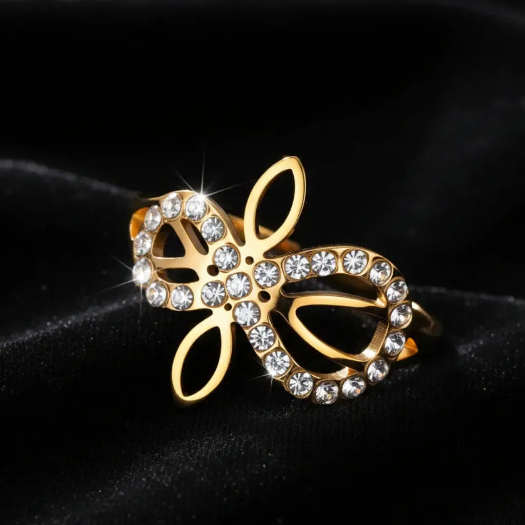 Gold Infinity Celtic knot zircon ring on black velvet, angled view highlighting the sparkle of the pave stones