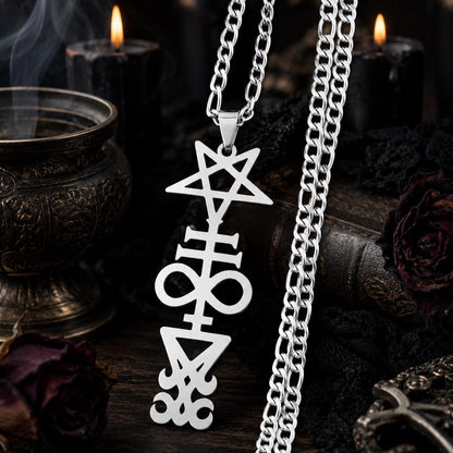 Silver stainless steel Inverted Pentagram Cross necklace with gothic occult sigil pendant, displayed with black candles and a smoking incense urn
