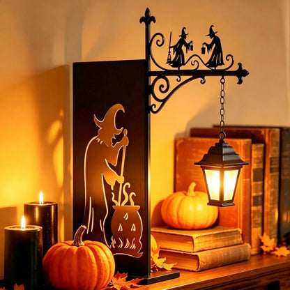 Iron witch lantern bookend lamp on shelf with pumpkins and candles