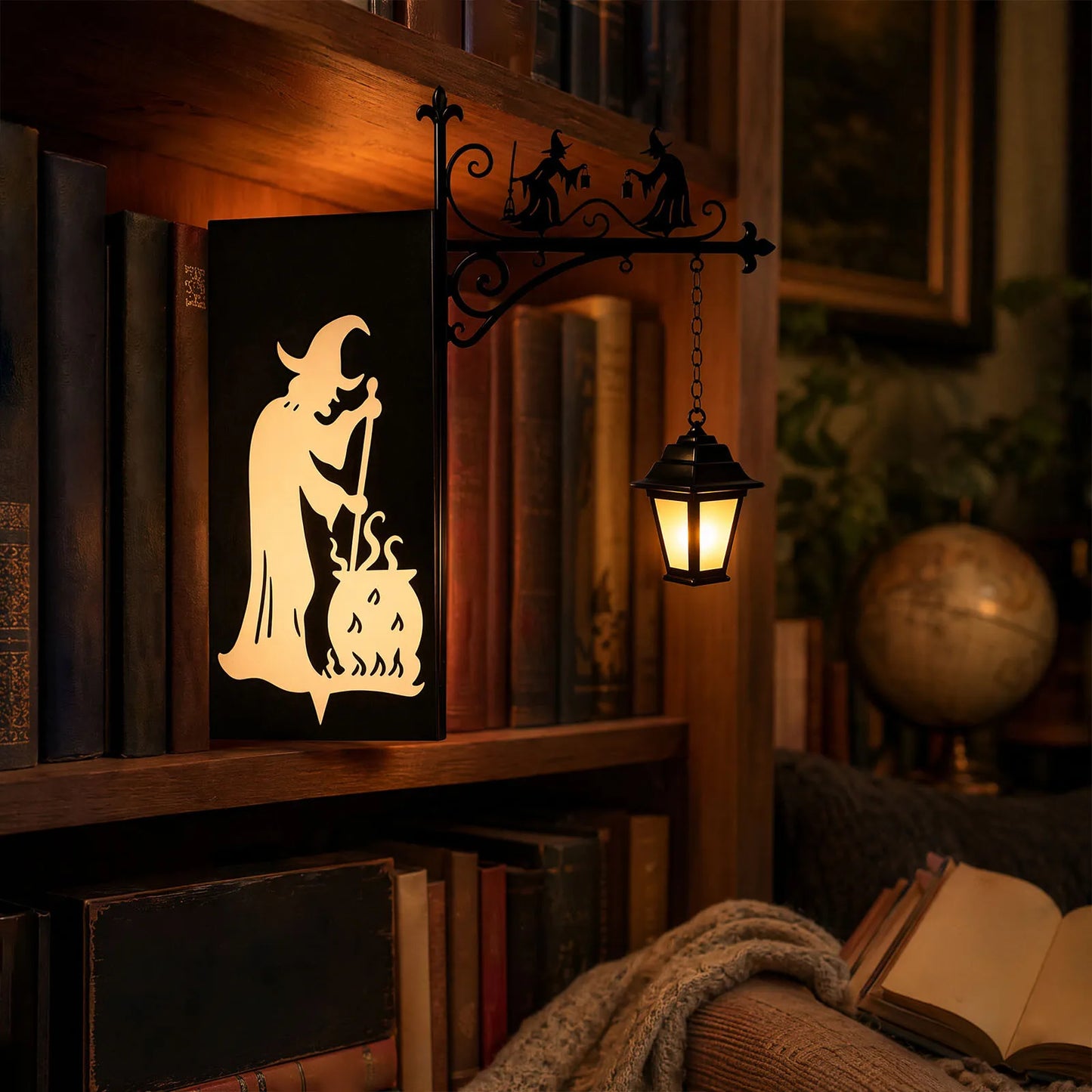 Iron witch silhouette bookend lamp glowing on gothic library bookshelf