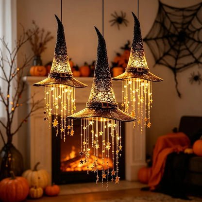 Witch hat chime glowing on a Halloween porch at night