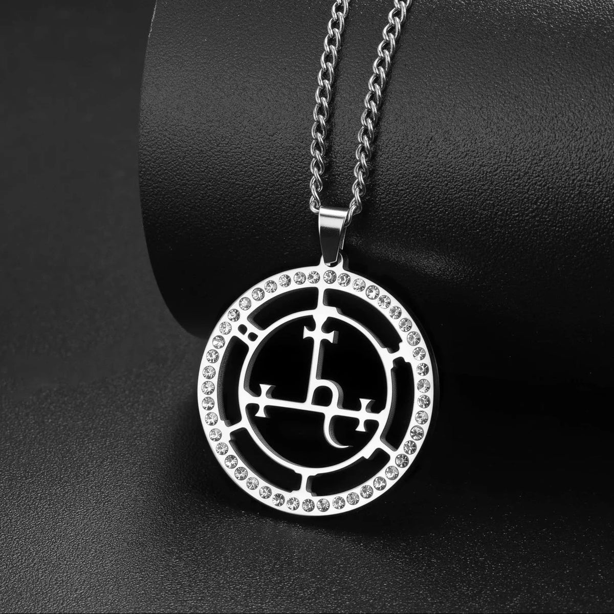 Occult amulet pendant shown flat with its link chain