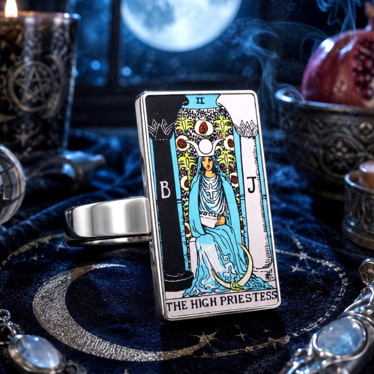 The High Priestess tarot card ring in stainless steel on a moonlit velvet altar with crystals