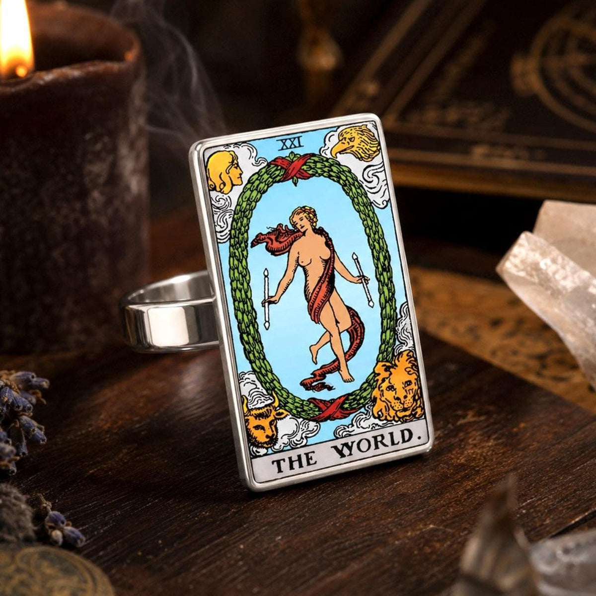 The World tarot card ring in stainless steel on aged wood with clear quartz and dried lavender