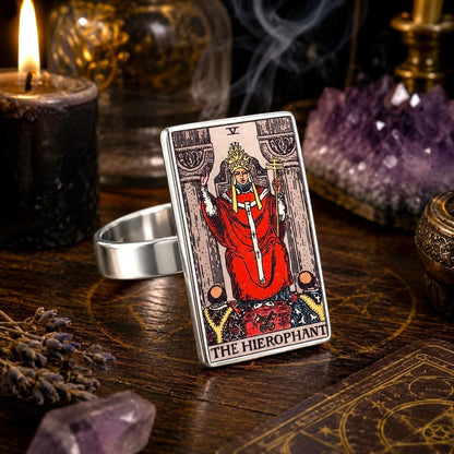 The Hierophant tarot card ring in stainless steel on a dark altar with amethyst and black candles