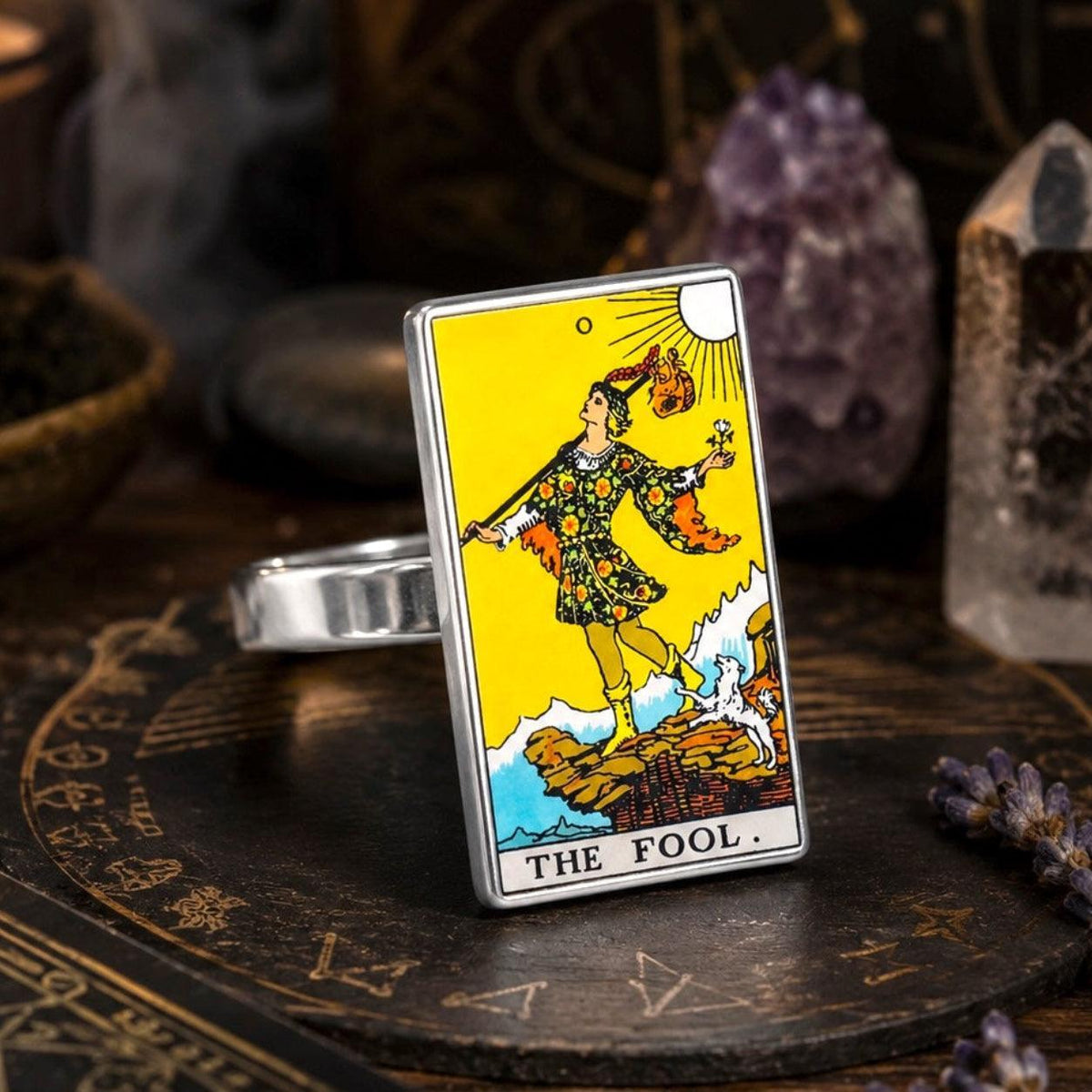 The Fool tarot card ring in stainless steel on a stone altar plate with amethyst and clear quartz