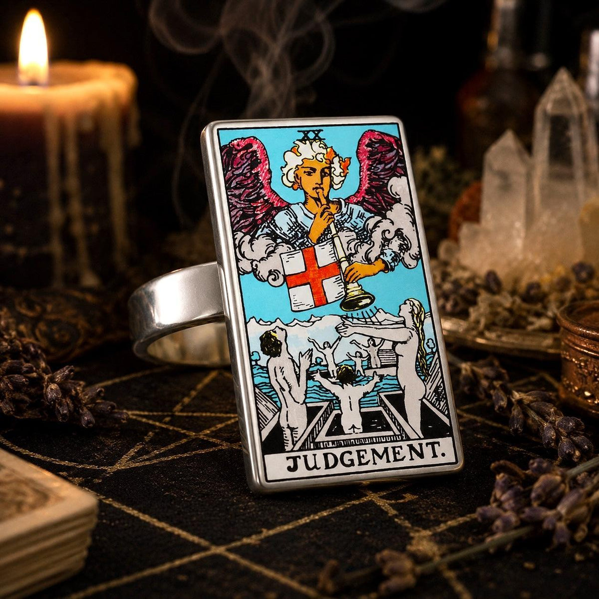Judgement tarot card ring in stainless steel on a pentacle altar cloth with dripping candles