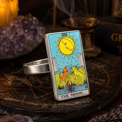 The Moon tarot card ring in stainless steel on a dark altar with amethyst clusters and gold sigils