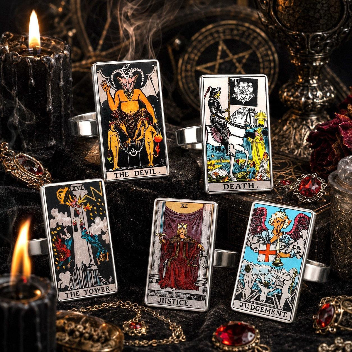 Five stainless steel tarot rings: The Devil, Death, The Tower, Justice and Judgement on a candlelit altar