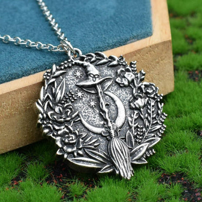 Captivating silver plated Moon Hat Broom Witch Halloween Necklace with intricate floral details.