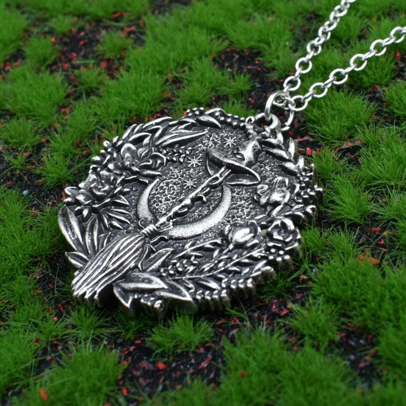 Captivating silver plated Moon Hat Broom Witch Halloween Necklace with intricate floral details.