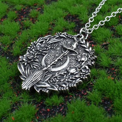 Captivating silver plated Moon Hat Broom Witch Halloween Necklace with intricate floral details.