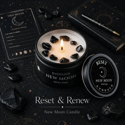 New Moon Candle Reset and Renew with black obsidian crystals in soy wax, intention-setting journal card, pen and moon phase icons on a starry dark background
