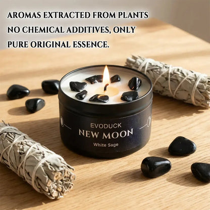New Moon Candle White Sage lit on wooden table with white sage smudge sticks and black obsidian stones - natural pure essence, no chemical additives