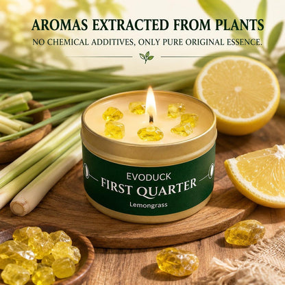 First Quarter Candle Lemongrass lit on wood board with citrine crystals, fresh lemongrass stalks and lemon slices - natural pure essence, no chemical additives
