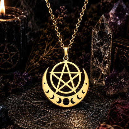 A gold pendant necklace featuring a pentagram and moon phases design, displayed on a dark altar with a crystal tower, candles, and a mystical board.