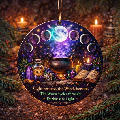 Round ceramic Yule ornament with glowing moon phases, a cauldron, candles, and "Light returns" text.